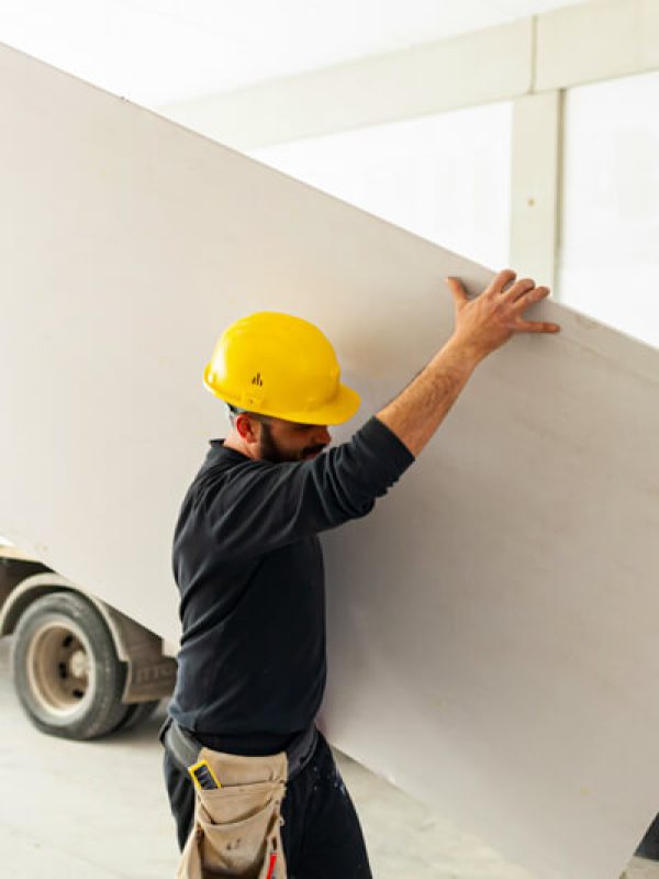 worker-builds-a-plasterboard-wall-2023-11-27-05-21-05-utc