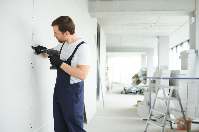 worker-builder-installs-plasterboard-drywall-at-a-2023-12-18-21-26-18-utc